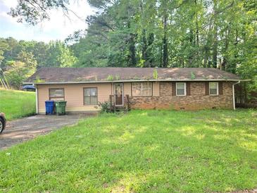 Single story home with a lawn and driveway, featuring mixed siding and brick at 715 Plainville Sw Dr, Atlanta, GA 30331