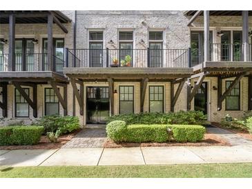 Multi-story townhome with brick facade and private balconies at 18 Peachtree Ne Ave # 5, Atlanta, GA 30305