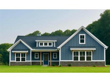 Charming blue home with white trim, stone accents, and a well-manicured lawn at 1273 Jersey Social Circle Rd, Covington, GA 30014