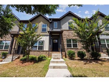 Charming townhome featuring a brick facade, landscaped front yard, and inviting entrance at 1004 Bayrose Cir, East Point, GA 30344