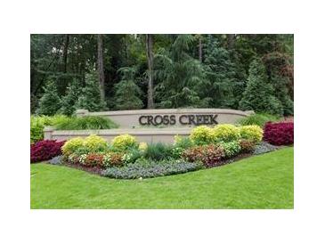 Landscaped Cross Creek community entrance sign with manicured plants and lush greenery at 37 La Rue Nw Pl, Atlanta, GA 30327