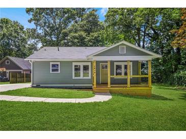 Charming home featuring a covered porch, well-kept lawn, and classic design with a modern exterior paint and ample natural light at 1675 White Oak Way, Decatur, GA 30032