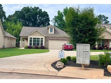 Charming single-story home with stone accents, lush lawn, and a well-maintained driveway at 245 Fenwick Cir, Mcdonough, GA 30253
