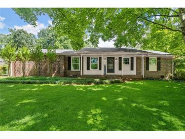 Charming brick home featuring a well-manicured lawn and a welcoming front porch at 2826 Summit Ridge Dr, Marietta, GA 30066