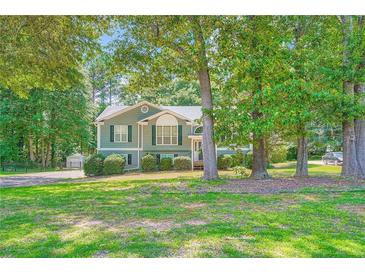 Inviting two-story home with lush landscaping and charming curb appeal at 113 Hitchcock Dr, Villa Rica, GA 30180
