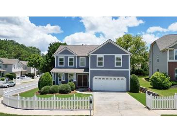 Charming two-story home with a well-manicured lawn and white picket fence at 4003 Coachman Ct, Cumming, GA 30040