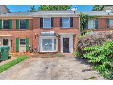 Charming brick townhome with a well-maintained front yard and covered entryway at 440 Forestgate Ct, Atlanta, GA 30350