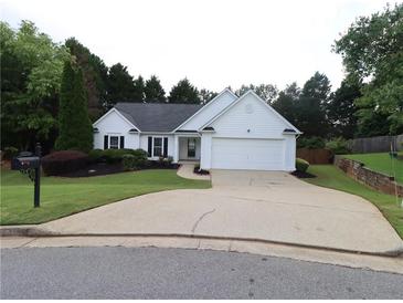 Charming one-story home featuring a well-maintained lawn and a paved driveway leading to an attached garage at 550 Sessingham Ct, Alpharetta, GA 30005
