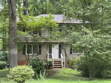 Charming two-story home with a wooded lot, dark shutters, and covered front entry at 372 Nalley Dr, Stone Mountain, GA 30087