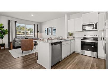Modern kitchen featuring white cabinets, stainless steel appliances, and granite countertops at 2810 Georgia Aster Nw Way # 6, Atlanta, GA 30318