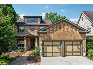 Charming brick two-story home with an attached two car garage and well maintained yard at 3405 Camellia Ln, Suwanee, GA 30024