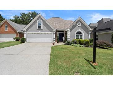 Charming one-story home with a well-manicured lawn, a two-car garage, and a welcoming front entrance at 170 Shelli Ln, Roswell, GA 30075