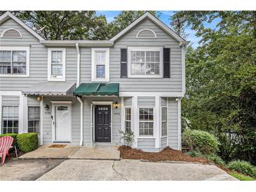Charming townhome featuring a gray exterior, covered entry, and well-maintained landscaping at 4098 Charlotte Se Ct, Smyrna, GA 30082