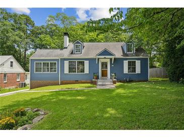Charming blue two-story home with dormer windows and a well-maintained lawn and mature trees at 1046 S Mcdonough St, Decatur, GA 30030