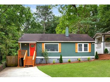 Charming single-story home with a well-manicured lawn, inviting porch and colorful door at 1258 Campbellton Sw Rd, Atlanta, GA 30310