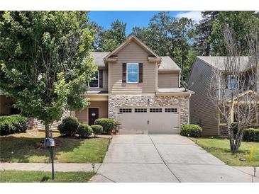 Charming two-story home featuring a stone front, attached two car garage and well-manicured lawn at 2780 Lakeview Walk, Decatur, GA 30035