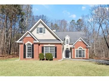 Charming brick and siding home with well-maintained lawn, mature trees, and a welcoming facade at 4021 Melvin Sw Dr, Atlanta, GA 30331