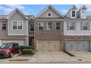 Charming townhomes with a brick and siding facade and attached two-car garages at 3931 Fireoak Dr, Decatur, GA 30032