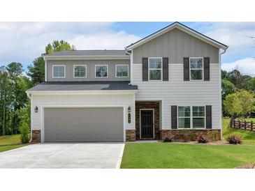 Charming two-story home with a gray two-car garage and a well-manicured front yard at 4563 Sweetlake Court Sw, Mableton, GA 30127