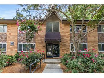 Attractive brick condo building exterior with stone accents and landscaping at 115 Biscayne Nw Dr # E3, Atlanta, GA 30309