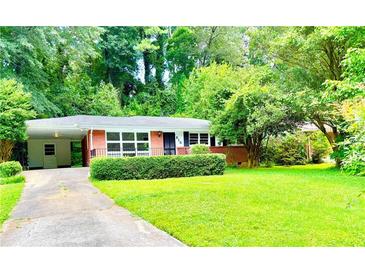 Charming brick home with a well-maintained lawn and beautiful mature trees surrounding the property at 813 Crockett Ct, Decatur, GA 30033