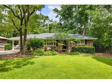 Charming brick home with a well-maintained front yard and mature trees at 2163 Medfield Ne Trl, Chamblee, GA 30345