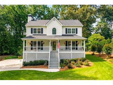 Charming two-story home featuring a spacious front porch, lush landscaping, and a welcoming curb appeal at 2401 Stockton Dr, Marietta, GA 30066