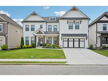 Charming two-story home with a well-manicured lawn and a classic white facade at 4189 Brookmont Way, Auburn, GA 30011