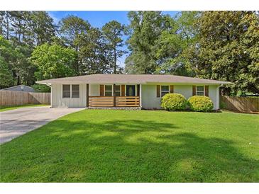 Charming single story brick home with manicured lawn, driveway, and welcoming, cozy feel at 470 Pretty View Se Ln, Smyrna, GA 30082