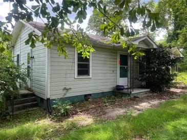 Cozy one-story home featuring light blue siding, a small porch, and a well-maintained yard at 2096 Boar Tusk Ne Rd, Conyers, GA 30012