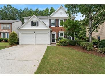 Charming two-story home featuring a well-manicured lawn and a two-car garage at 475 Chippenham Ct, Alpharetta, GA 30005