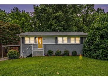 Charming single story home with gray brick and siding, grassy front lawn and updated stairs to the yellow front door at 232 Whitworth Sw Dr, Atlanta, GA 30331