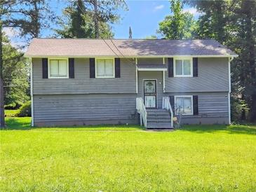 Charming two-story home with a well-maintained lawn, gray siding, black shutters and a welcoming front entrance at 9218 River Chase Way, Jonesboro, GA 30238