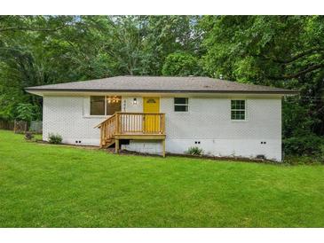 Charming painted brick home with a bright yellow front door and inviting front porch at 4443 Flat Shoals Pkwy, Decatur, GA 30034