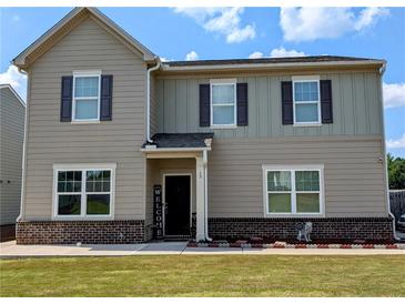 Charming two-story home with neutral siding, dark shutters, and a welcoming front porch at 15 Regal Ln, Covington, GA 30016