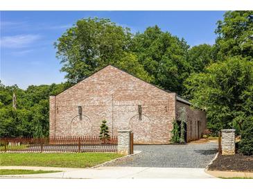 Unique brick building with professional landscaping and stylish stone and iron fence at 538 Main St, Palmetto, GA 30268