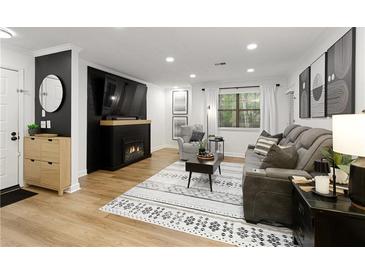 Cozy living room featuring a fireplace, comfortable seating, and stylish decor at 107 Barrington Hills Dr, Atlanta, GA 30350