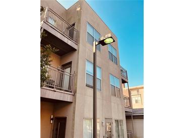 Multi-story condo features balconies, neutral stucco, large windows and a blue sky at 238 Walker Sw St # 22, Atlanta, GA 30313