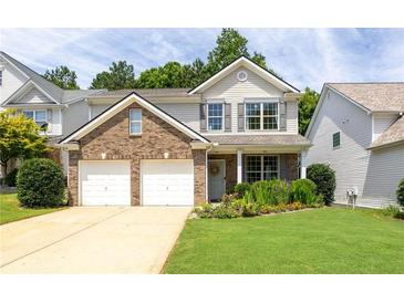 Charming two-story home featuring a brick facade, gray shutters, a two-car garage, and a well-manicured front yard at 167 Diamond Ridge Ave, Canton, GA 30114