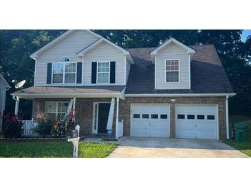 Charming two-story home with a brick facade, covered porch, and two-car garage at 1793 Cutters Mill Way, Lithonia, GA 30058