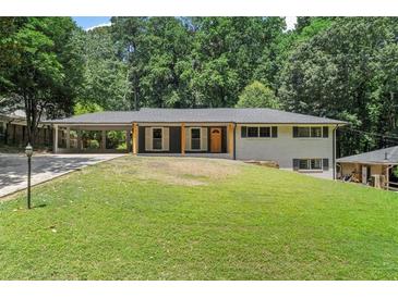 Charming single-story home featuring a covered carport and a large, lush front yard at 6456 Wright Ne Rd, Atlanta, GA 30328