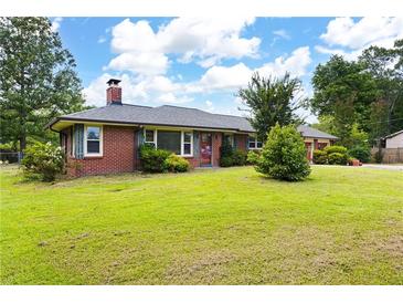 Charming brick home with a well-maintained lawn and mature trees at 1191 S Burnt Hickory Rd, Douglasville, GA 30134
