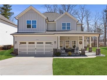 Charming two-story home with a welcoming front porch, two-car garage, and well-manicured lawn at 1784 Treymire Ct, Stone Mountain, GA 30088