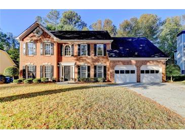 Beautiful two-story brick home with a well-manicured lawn and a two-car garage at 3034 Brookgreen Trl, Lawrenceville, GA 30043