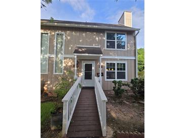 Inviting two-story home with a wooden walkway leading to the front door and a well-maintained yard at 1297 Tree Creek Ct, Clarkston, GA 30021