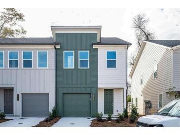 Charming two-story townhouse with a green front door and garage at 1648 Florence Nw Run, Atlanta, GA 30318