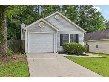 Charming single-story home featuring a one-car garage and well-maintained lawn at 1528 Wembley Dr, Douglasville, GA 30134
