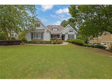Charming home with a lush, green front yard and well-maintained landscaping at 130 Holly Reserve Pkwy, Canton, GA 30114