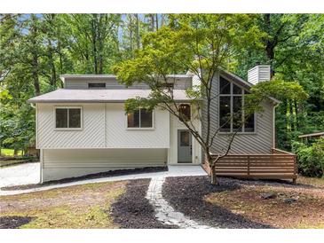 Charming home featuring a unique architectural design, complemented by lush landscaping at 515 Dover St, Marietta, GA 30066