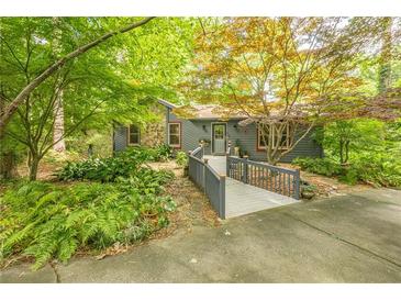 Charming home featuring a ramp walkway, stone accents, and lush landscaping, creating an inviting entrance at 5848 Kingswood Ct, Norcross, GA 30093